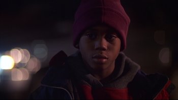 Movie still from “Soul Food” (1997), directed by George Tillman Jr. – A young boy wearing a red hat in the dark; Close Up shot, Low angle