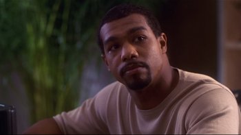 Movie still from “Soul Food” (1997), directed by George Tillman Jr. – A person wearing a white t - shirt; Close Up shot, High angle