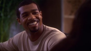 Movie still from “Soul Food” (1997), directed by George Tillman Jr. – A person smiling at the camera; Close Up shot, Over the shoulder angle