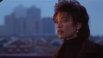 Movie still from “Soul Food” (1997), directed by George Tillman Jr. – A person wearing a black shirt; Close Up shot, Over the shoulder angle