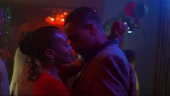 Movie still from “Soul Food” (1997), directed by George Tillman Jr. – A man and a woman are dancing in a room; Close Up shot, Low angle