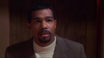 Movie still from “Soul Food” (1997), directed by George Tillman Jr. – A person wearing a suit; Close Up shot, High angle
