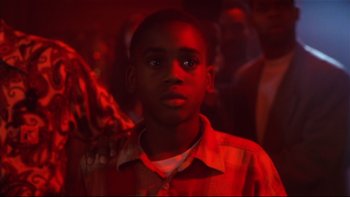 Movie still from “Soul Food” (1997), directed by George Tillman Jr. – A young boy is standing in a red light; Close Up shot, Low angle