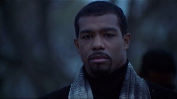 Movie still from “Soul Food” (1997), directed by George Tillman Jr. – A person wearing a scarf; Close Up shot, Low angle