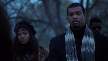Movie still from “Soul Food” (1997), directed by George Tillman Jr. – A man and a woman standing next to each other in a forest; Medium shot, Low angle