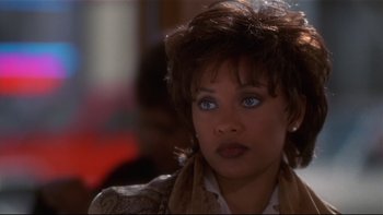Movie still from “Soul Food” (1997), directed by George Tillman Jr. – A person with short brown hair; Close Up shot, Over the shoulder angle