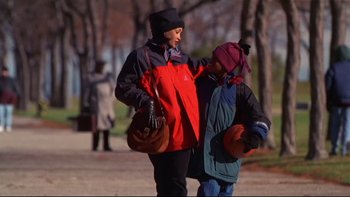 Movie still from “Soul Food” (1997), directed by George Tillman Jr. – A woman and a child walking on a sidewalk; Medium shot, Low angle