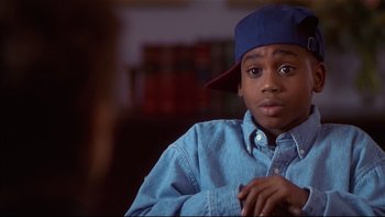 Movie still from “Soul Food” (1997), directed by George Tillman Jr. – A young man wearing a blue hat and a blue shirt; Close Up shot, High angle