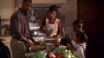 Movie still from “Soul Food” (1997), directed by George Tillman Jr. – A group of people in a kitchen preparing food; Medium shot, High angle
