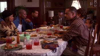Movie still from “Soul Food” (1997), directed by George Tillman Jr. – A group of people sitting at a table eating; Medium shot, High angle