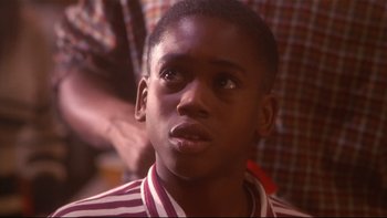 Movie still from “Soul Food” (1997), directed by George Tillman Jr. – A young person looking up; Close Up shot, Over the shoulder angle