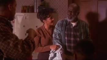 Movie still from “Soul Food” (1997), directed by George Tillman Jr. – An older man and a younger woman holding a towel; Medium shot, Over the shoulder angle
