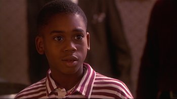 Movie still from “Soul Food” (1997), directed by George Tillman Jr. – A young person with a striped shirt; Close Up shot, High angle