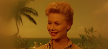 Movie still from “South Pacific” (1958), directed by Joshua Logan – A woman with blonde hair smiling for the camera; Close Up shot, Low angle