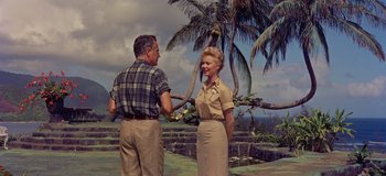 Movie still from “South Pacific” (1958), directed by Joshua Logan – An older man and a younger woman shaking hands; Wide shot, Low angle