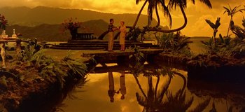 Movie still from “South Pacific” (1958), directed by Joshua Logan – Two people are standing on a dock near a body of water; Extreme Wide shot, Low angle