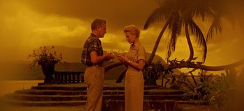 Movie still from “South Pacific” (1958), directed by Joshua Logan – A man and a woman are holding wine glasses; Wide shot, Low angle