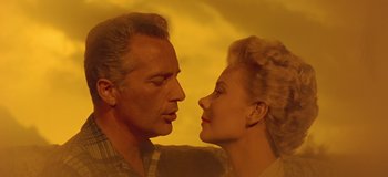 Movie still from “South Pacific” (1958), directed by Joshua Logan – A man and a woman face to face in front of a yellow background; Close Up shot, Low angle