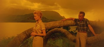 Movie still from “South Pacific” (1958), directed by Joshua Logan – A woman standing in front of a tree branch; Wide shot, Low angle