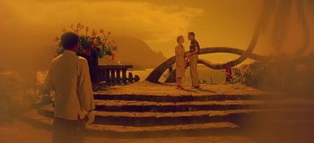 Movie still from “South Pacific” (1958), directed by Joshua Logan – Two people standing on steps near a body of water; Extreme Wide shot, Low angle