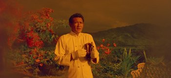 Movie still from “South Pacific” (1958), directed by Joshua Logan – A man holding a banana while standing in front of a painting; Medium shot, Low angle