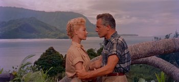 Movie still from “South Pacific” (1958), directed by Joshua Logan – An older man and a younger woman holding each other; Medium shot, Low angle