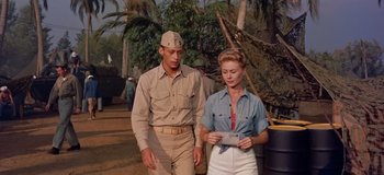 Movie still from “South Pacific” (1958), directed by Joshua Logan – A man and a woman standing next to each other; Medium shot, Low angle