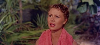 Movie still from “South Pacific” (1958), directed by Joshua Logan – A woman with a pink towel around her neck; Close Up shot, High angle