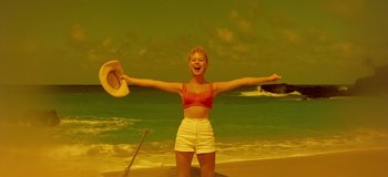 Movie still from “South Pacific” (1958), directed by Joshua Logan – A woman standing on the beach with her arms outstretched; Wide shot, Low angle