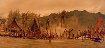 Movie still from “South Pacific” (1958), directed by Joshua Logan – A group of people standing on top of a sandy beach; Extreme Wide shot, High angle