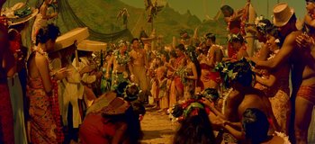 Movie still from “South Pacific” (1958), directed by Joshua Logan – A group of people standing around a crowd of people; Wide shot, High angle