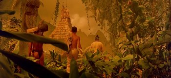 Movie still from “South Pacific” (1958), directed by Joshua Logan – Two people in a jungle with a tree in front of them; Extreme Wide shot, Low angle