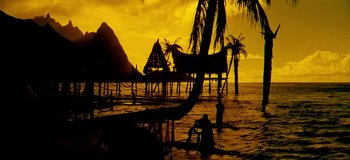 Movie still from “South Pacific” (1958), directed by Joshua Logan – Two people in the water at sunset near a pier; Extreme Wide shot, Low angle