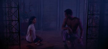 Movie still from “South Pacific” (1958), directed by Joshua Logan – A man and a woman sitting in a room; Wide shot, High angle