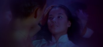 Movie still from “South Pacific” (1958), directed by Joshua Logan – A young woman looking into a mirror while a man touches her hair; Close Up shot, High angle