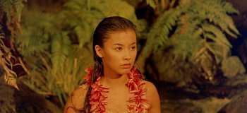 Movie still from “South Pacific” (1958), directed by Joshua Logan – A young woman wearing a red flower lei; Close Up shot, High angle