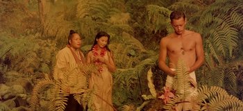 Movie still from “South Pacific” (1958), directed by Joshua Logan – A man standing next to two women in a forest; Wide shot, High angle