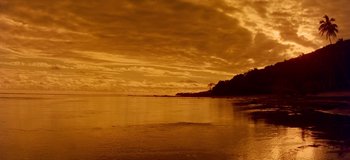 Movie still from “South Pacific” (1958), directed by Joshua Logan – A view of a body of water and a cloudy sky; Extreme Wide shot, High angle
