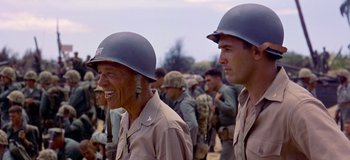 Movie still from “South Pacific” (1958), directed by Joshua Logan – A couple of men in military uniforms standing next to each other; Close Up shot, Over the shoulder angle