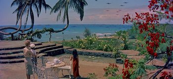 Movie still from “South Pacific” (1958), directed by Joshua Logan – A little girl standing on the beach looking out at the ocean; Extreme Wide shot, High angle