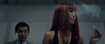 Movie still from “Southland Tales” (2006), directed by Richard Kelly – A woman with red hair is looking at the mirror; Close Up shot, Low angle