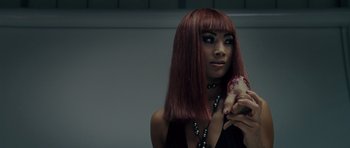 Movie still from “Southland Tales” (2006), directed by Richard Kelly – A woman with red hair holding a piece of meat; Close Up shot, Over the shoulder angle