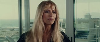 Movie still from “Southland Tales” (2006), directed by Richard Kelly – A woman with long blonde hair looking at the camera; Close Up shot, Over the shoulder angle