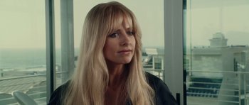 Movie still from “Southland Tales” (2006), directed by Richard Kelly – A woman with long blonde hair and bangs looking off to her right; Close Up shot, Over the shoulder angle
