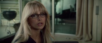 Movie still from “Southland Tales” (2006), directed by Richard Kelly – A woman wearing glasses and a black shirt; Close Up shot, Over the shoulder angle