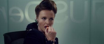 Movie still from “Southland Tales” (2006), directed by Richard Kelly – A woman holding a piece of food in her hand; Close Up shot, Over the shoulder angle