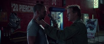 Movie still from “Southland Tales” (2006), directed by Richard Kelly – A man holding a gun up to another man's face; Close Up shot, Over the shoulder angle