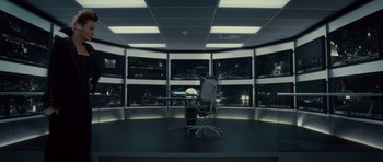 Movie still from “Southland Tales” (2006), directed by Richard Kelly – An empty chair in front of a window in a dark room; Wide shot, High angle