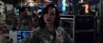 Movie still from “Southland Tales” (2006), directed by Richard Kelly – A woman in military fatigues is looking at the camera; Close Up shot, Over the shoulder angle