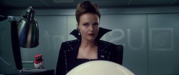 Movie still from “Southland Tales” (2006), directed by Richard Kelly – A woman in a black jacket sitting in front of a mirror; Close Up shot, Over the shoulder angle